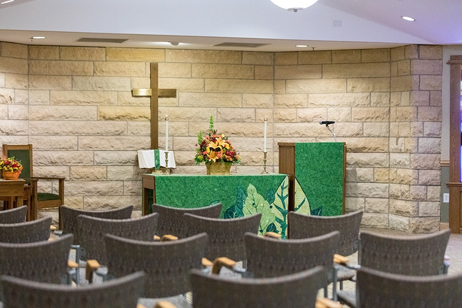 Chapel With Gold Cross Behind Alter