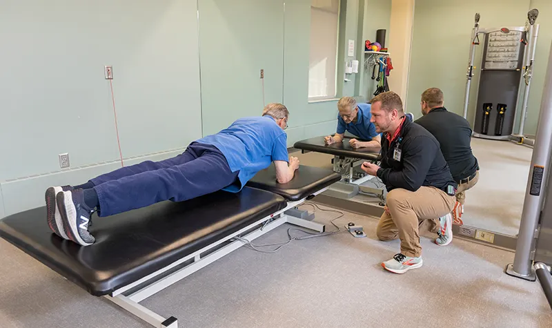 Trainer Guiding Resident In Fitness Routine