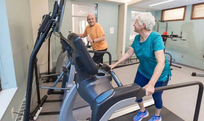 Two Residents Using Cardio Machines