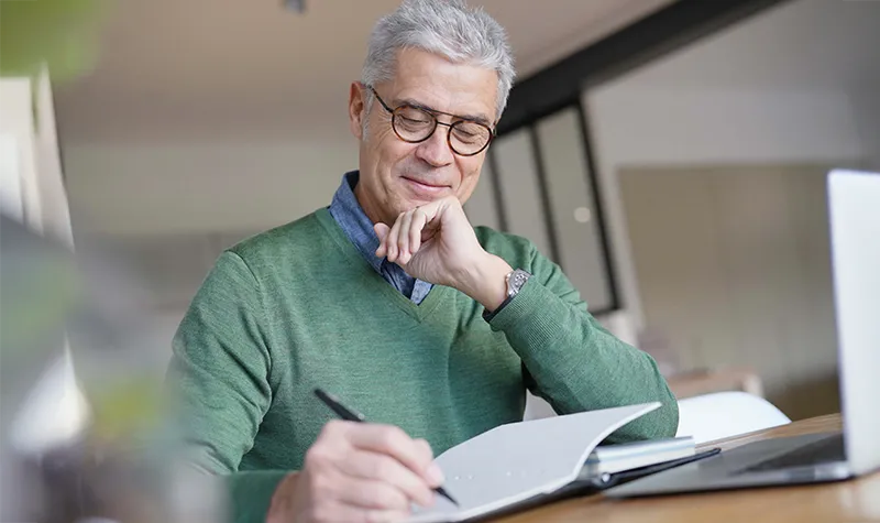 Senior Man Writing In Journal