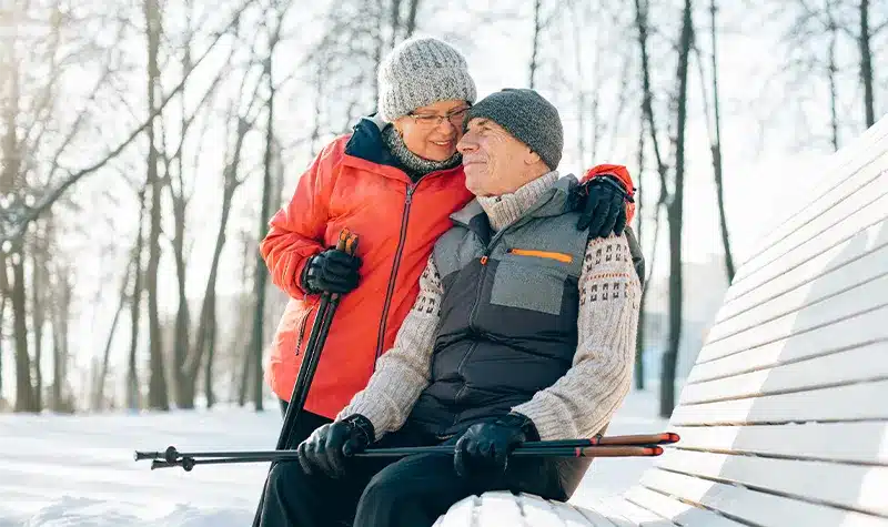 Elderly Couple Outside Enjoying The Snow