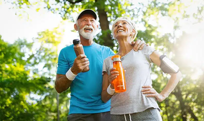 Senior Couple Outdoors Holding Water Bottles