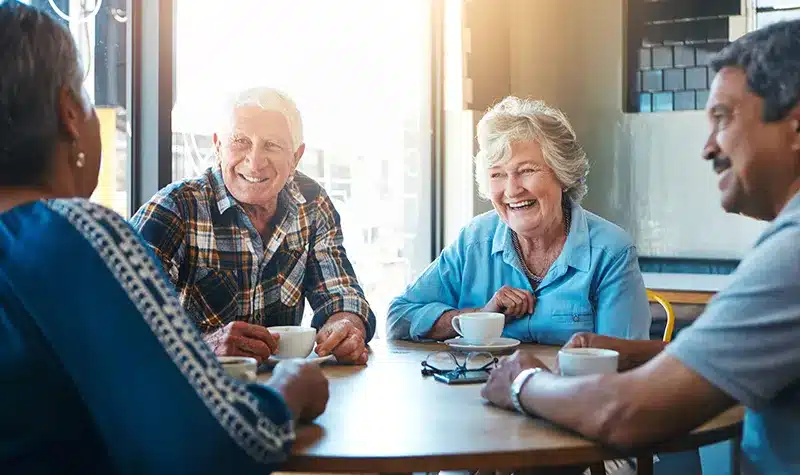 Elderly Couples Enjoying Coffee At Table Elderly Couples Enjoying Coffee At Table