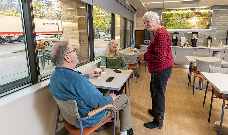 Residents Having A Conversation In Cafe