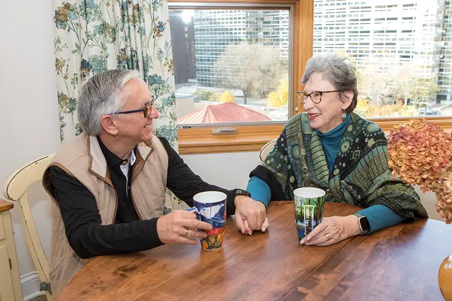 Ch Residents Sitting At Table Looking At Each Other