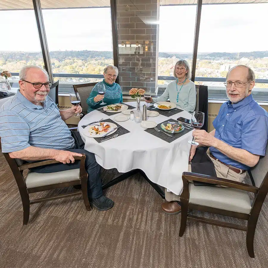 Group Of Residents Sitting At Table Near Window
