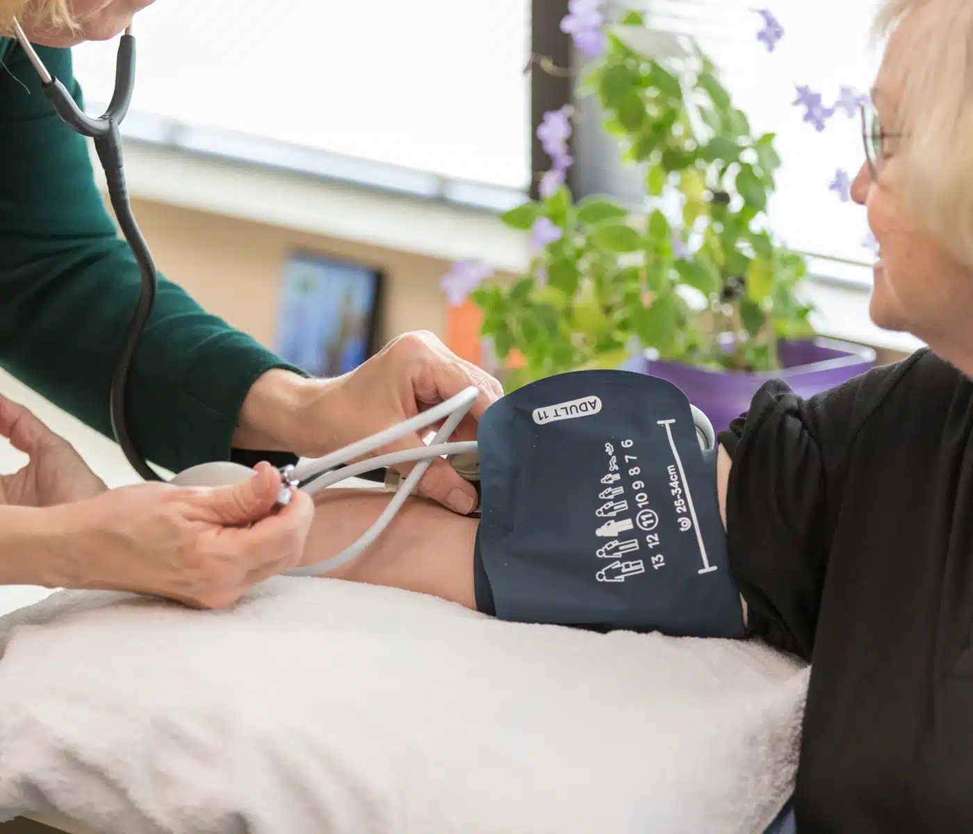 Nurse Taking Blood Pressure With Arm Cuff