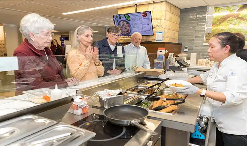 Residents Standing In Line For A Meal