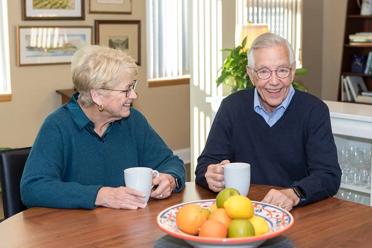 Couple Sitting At Dining Table